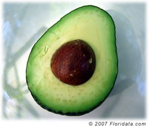 A sliced avocado reveals it's creamy deliciousness.