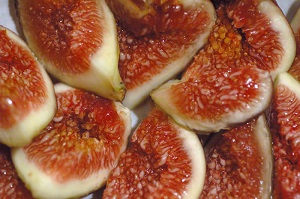 Fresh figs cut open showing the flesh and seeds inside